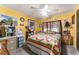 This bedroom features a patchwork quilt, ceiling fan, and workstation at 710 Dolphin Dr, Tavares, FL 32778