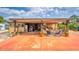 Cozy carport featuring outdoor seating and decor, perfect for relaxing and entertaining guests at 710 Dolphin Dr, Tavares, FL 32778