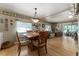 Open dining area flowing into a cozy living room with natural light and hardwood floors at 710 Dolphin Dr, Tavares, FL 32778
