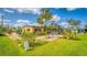 Well-maintained exterior with a landscaped yard and screened-in porch at 710 Dolphin Dr, Tavares, FL 32778