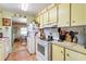 Bright kitchen with white appliances and light yellow cabinets at 710 Dolphin Dr, Tavares, FL 32778