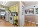 Functional kitchen with white appliances and light yellow cabinetry at 710 Dolphin Dr, Tavares, FL 32778