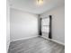Neutral bedroom with wood-look flooring, baseboards, and natural light from the window at 717 Robin Ct, Kissimmee, FL 34759