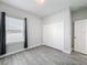 Bedroom with wood-look tile floors, a large closet, and a bright window at 717 Robin Ct, Kissimmee, FL 34759