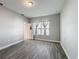 Cozy bedroom with natural light and wood-look tile flooring at 717 Robin Ct, Kissimmee, FL 34759