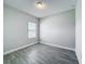 Clean bedroom with wood-look flooring, neutral walls, and a sunny window at 717 Robin Ct, Kissimmee, FL 34759