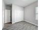 Cozy bedroom featuring wood-look tile flooring, closet, and a bright window at 717 Robin Ct, Kissimmee, FL 34759