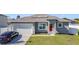 Charming one-story home featuring a red front door, garage, and well-manicured lawn at 717 Robin Ct, Kissimmee, FL 34759