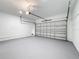Clean and well-lit two car garage with epoxy painted floor and an automatic garage door at 717 Robin Ct, Kissimmee, FL 34759