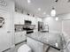 Bright kitchen featuring stainless steel appliances, granite counters, and ample cabinet space at 717 Robin Ct, Kissimmee, FL 34759
