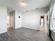Bright living room featuring neutral walls, gray wood-look tile flooring, and ample natural light at 717 Robin Ct, Kissimmee, FL 34759