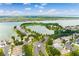 An aerial perspective highlighting the serene neighborhood with the lake and manicured landscaping at 724 Barefoot Bay Loop, Groveland, FL 34736