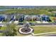 Aerial view of homes along a waterfront community, showcasing a playground and lake view at 724 Barefoot Bay Loop, Groveland, FL 34736