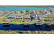 Aerial view of waterfront homes featuring private docks and boat lifts on a lake at 724 Barefoot Bay Loop, Groveland, FL 34736
