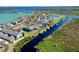 Aerial view showcasing the waterfront homes and boat docks in a charming community at 724 Barefoot Bay Loop, Groveland, FL 34736