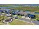 Scenic aerial view showcasing a waterfront community, park, and homes along a beautiful lake at 724 Barefoot Bay Loop, Groveland, FL 34736