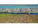 Scenic aerial view of waterfront homes with private docks and boat lifts along the tranquil lake at 724 Barefoot Bay Loop, Groveland, FL 34736