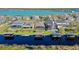 Aerial view of waterfront homes featuring private docks and boat lifts on a lake at 724 Barefoot Bay Loop, Groveland, FL 34736