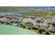 Aerial view of upscale waterfront homes and serene lake in a picturesque community at 724 Barefoot Bay Loop, Groveland, FL 34736