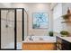 Bathroom features a glass-enclosed shower, a soaking tub with decorative tile surround, and modern fixtures at 724 Barefoot Bay Loop, Groveland, FL 34736