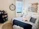 Cozy bedroom with charming decor, comfortable bed, and soothing neutral tones, showcasing style at 724 Barefoot Bay Loop, Groveland, FL 34736
