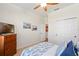 Bedroom with nautical decor, dresser, and closet space featuring blue bedding and accents at 724 Barefoot Bay Loop, Groveland, FL 34736