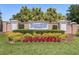 The Waterside Pointe community sign is surrounded by lush, colorful landscaping, creating a welcoming entrance at 724 Barefoot Bay Loop, Groveland, FL 34736