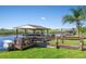 Private dock with boat lift, providing direct access to the water, perfect for boating enthusiasts at 724 Barefoot Bay Loop, Groveland, FL 34736