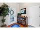 Warm entryway features decorative cabinet with nautical decor, a plant, and a decorative front door at 724 Barefoot Bay Loop, Groveland, FL 34736