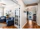 Inviting entryway with wood floors, decorative door, and an open view into living area at 724 Barefoot Bay Loop, Groveland, FL 34736