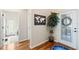 Inviting foyer with hardwood floors, a decorative world map and plant, and a white front door at 724 Barefoot Bay Loop, Groveland, FL 34736