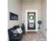 Cozy front porch featuring a welcome sign, bench with pillows, and a wreath on the front door at 724 Barefoot Bay Loop, Groveland, FL 34736