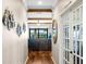 Bright hallway featuring wood floors, decorative wall art, and a view into the living area beyond at 724 Barefoot Bay Loop, Groveland, FL 34736