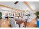 Open concept living space featuring a kitchen, dining area, living room with a large sofa and television at 724 Barefoot Bay Loop, Groveland, FL 34736