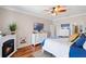 Well-lit bedroom featuring a fireplace, white dresser, and a view of the en-suite bathroom, providing a cozy retreat at 724 Barefoot Bay Loop, Groveland, FL 34736