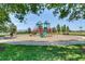Community playground with slides, climbing structures, and ample play space for children in a green, park-like setting at 724 Barefoot Bay Loop, Groveland, FL 34736