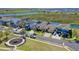 A suburban street view of modern homes with landscaped yards, and a community playground at 724 Barefoot Bay Loop, Groveland, FL 34736