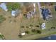 Aerial view of a house with large yard, pool, detached garage, and surrounding residences at 7729 Lake Andrea Cir, Mount Dora, FL 32757
