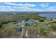 Aerial view of property with pin showing location near the lake and a lush landscape at 7729 Lake Andrea Cir, Mount Dora, FL 32757