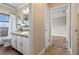 Stylish bathroom features vanity with white sink, a mirror, and an adjacent bedroom at 7729 Lake Andrea Cir, Mount Dora, FL 32757