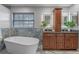 Elegant bathroom features a soaking tub, a modern vanity, and contemporary style at 7729 Lake Andrea Cir, Mount Dora, FL 32757