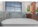 Bright bathroom featuring a freestanding tub and marble tile backsplash at 7729 Lake Andrea Cir, Mount Dora, FL 32757