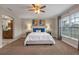 Spacious carpeted main bedroom with decor, ceiling fan, and a bright, airy feel at 7729 Lake Andrea Cir, Mount Dora, FL 32757