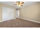Comfortable bedroom with a ceiling fan, closet, and neutral colors, offering a cozy and inviting atmosphere at 7729 Lake Andrea Cir, Mount Dora, FL 32757