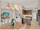Inviting dining area with a chandelier and access to the kitchen, enhancing the home's entertaining capabilities at 7729 Lake Andrea Cir, Mount Dora, FL 32757