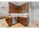 Well-organized kitchen featuring a granite countertop, stainless steel dishwasher, and ample storage space at 7729 Lake Andrea Cir, Mount Dora, FL 32757