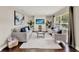 Bright living room features a large window, neutral colors, and a decorative media center at 7729 Lake Andrea Cir, Mount Dora, FL 32757
