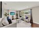 Comfortable living room featuring a large window, neutral colors, and a decorative media center at 7729 Lake Andrea Cir, Mount Dora, FL 32757