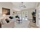 Bright living room features a ceiling fan, neutral color palette, and french doors to the backyard at 7729 Lake Andrea Cir, Mount Dora, FL 32757