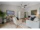Well-lit living room with comfortable seating, TV, and stylish decor, creating a cozy and inviting atmosphere at 7729 Lake Andrea Cir, Mount Dora, FL 32757